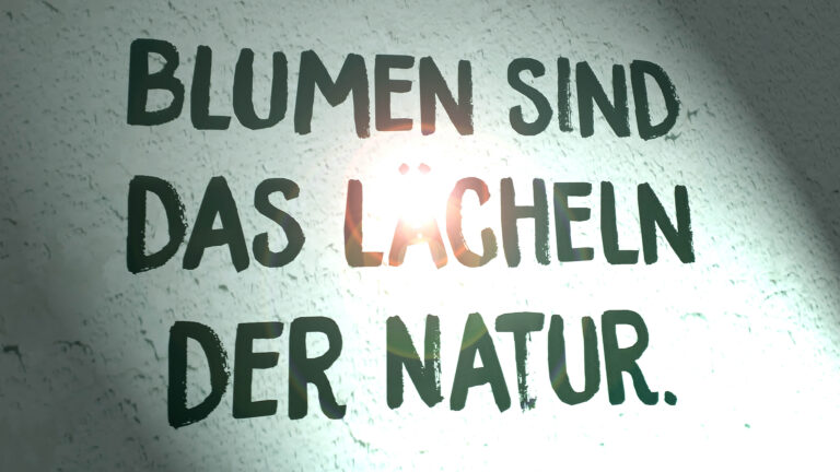 Schriftzug: Blumen sind das Lächeln der Natur