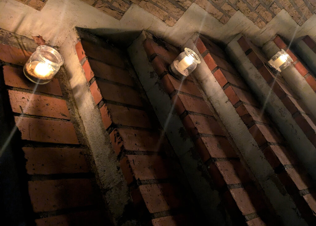 Kerzen in Gläsern stehen auf mehreren Treppenstufen